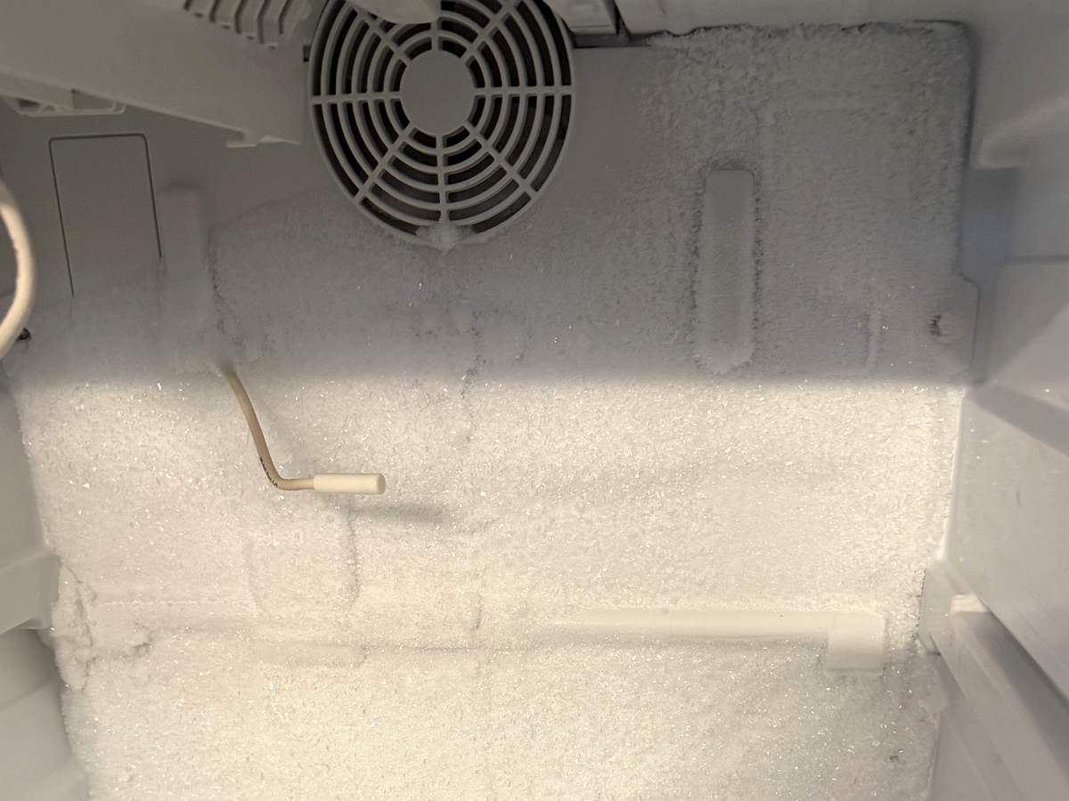 Heavy frost buildup on the evaporator of a built-in freezer with a failed defrost system
