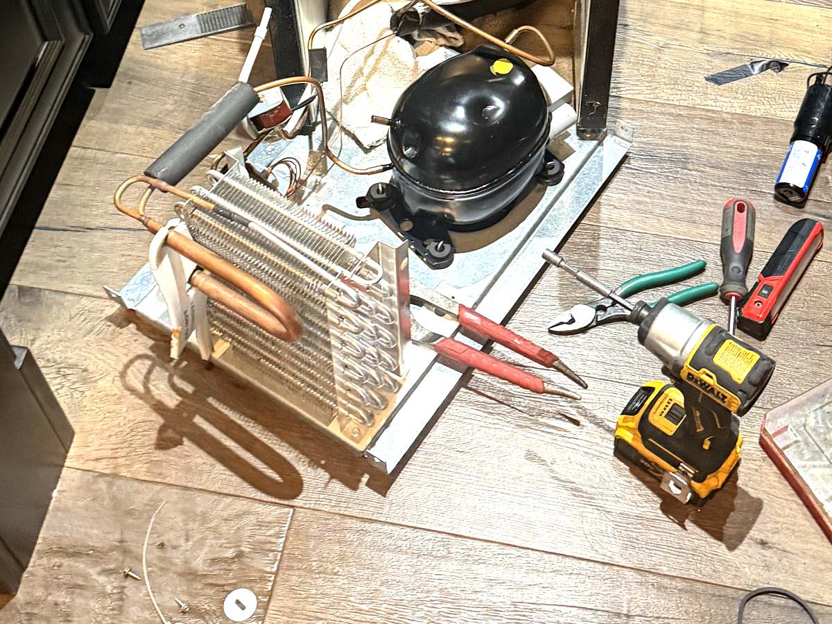 Condenser coil and compressor removed from a Monogram wine cooler