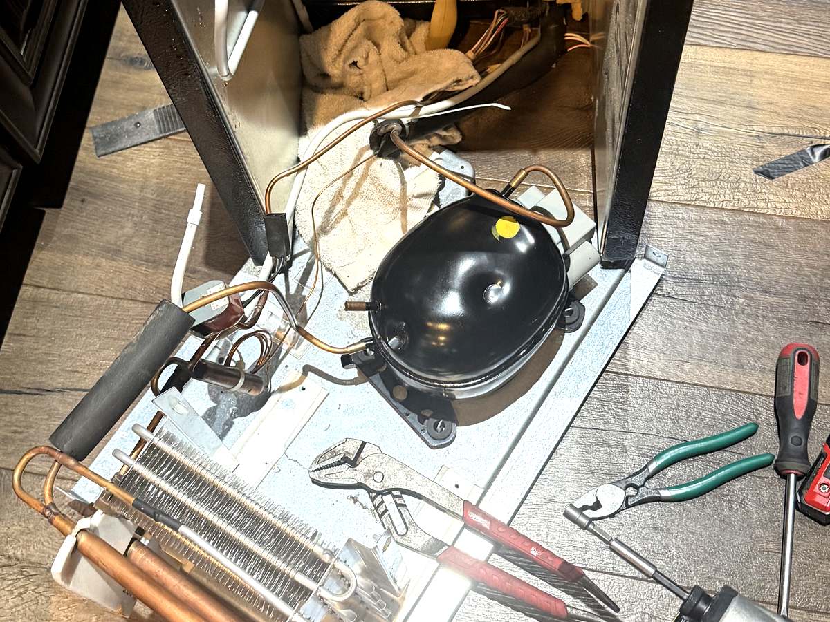 Monogram wine cooler compressor and condenser coil removed during a sealed system repair